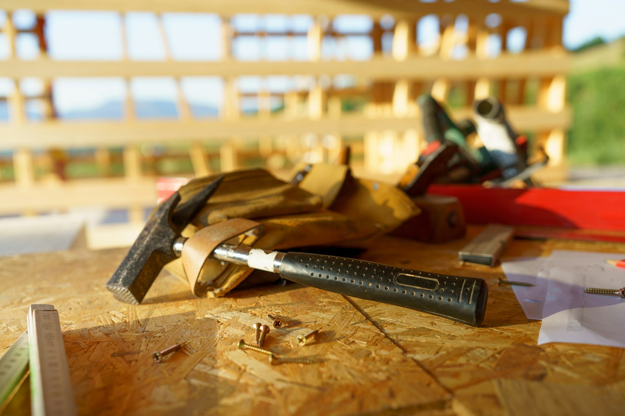 Close up of construction tools inside of unfinished wooden house.